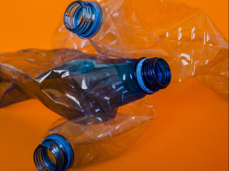 blue plastic bottle on orange surface