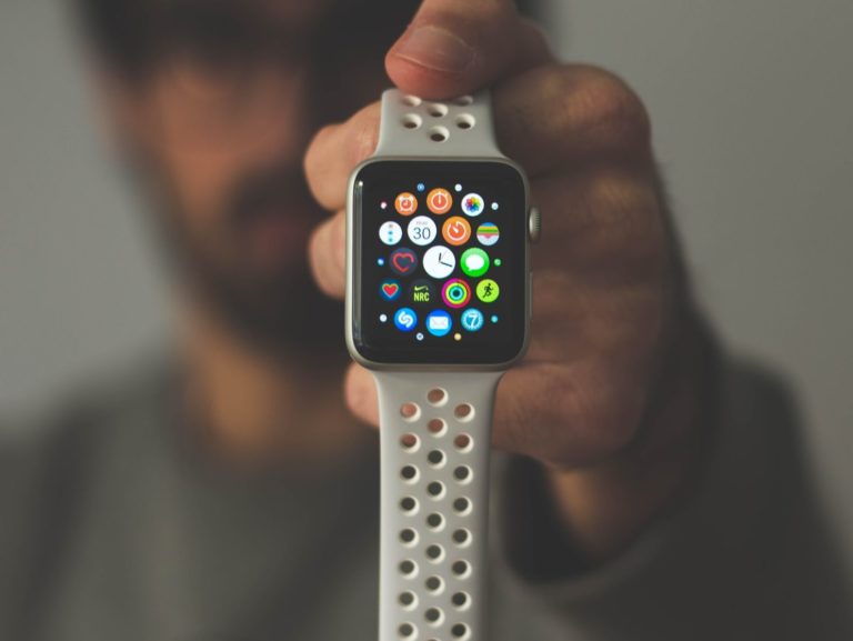 person holding silver aluminum case Apple Watch