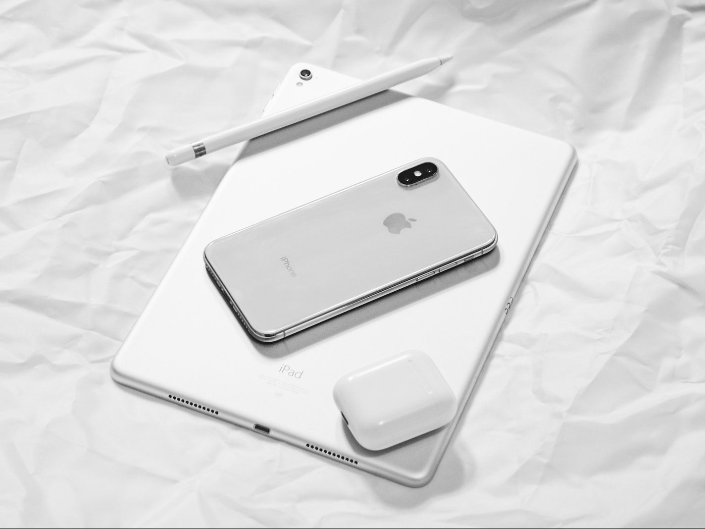 silver iPhone X with silver iPad