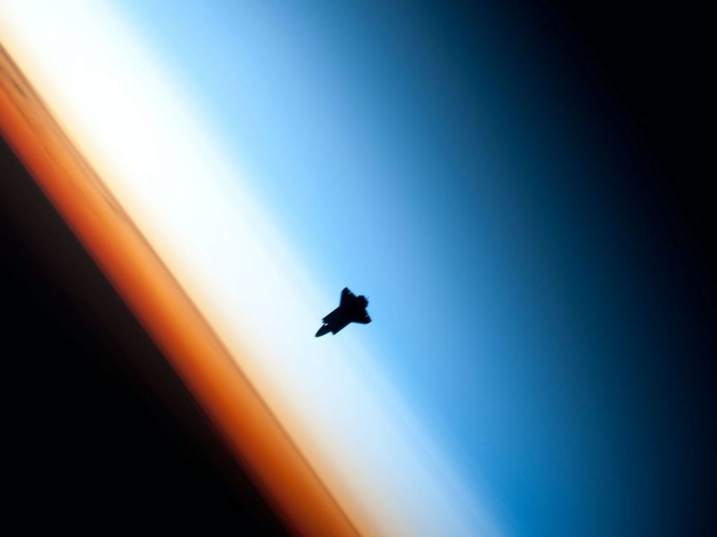 Space Shuttle orbits above earth atmosphere
