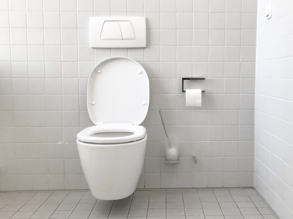 white toilet bowl with cistern