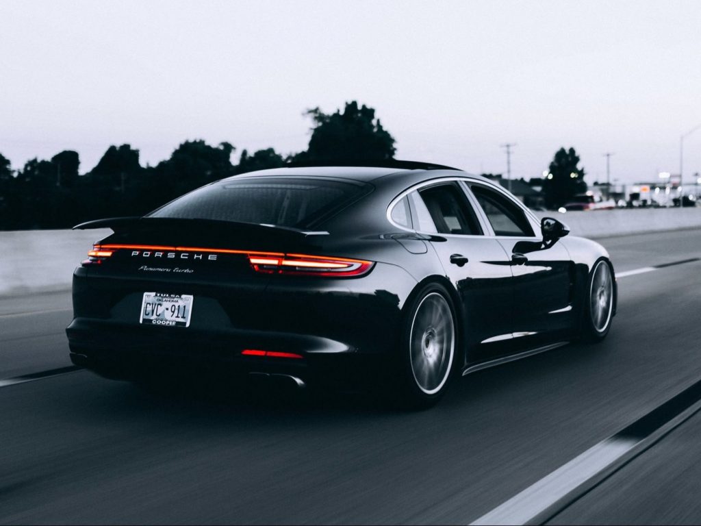 running black Porsche sedan