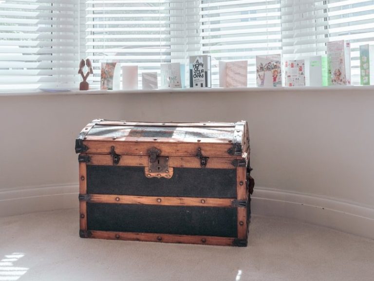 brown wooden chest box near white window blinds
