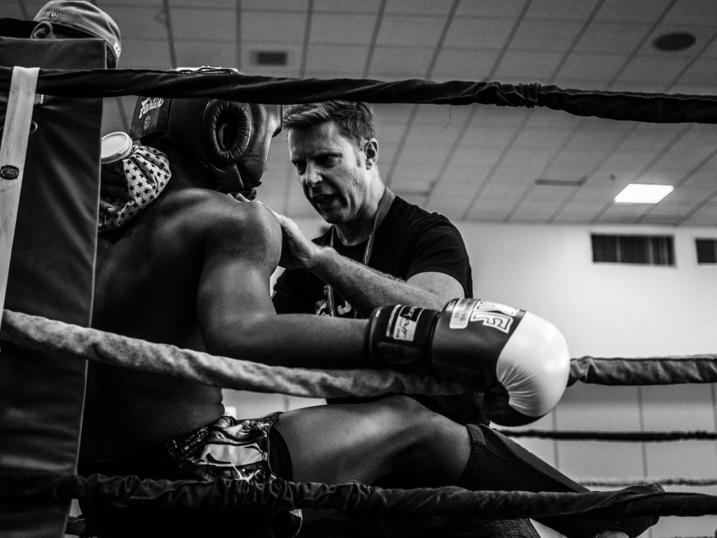 greyscale photography of a boxer inside reing