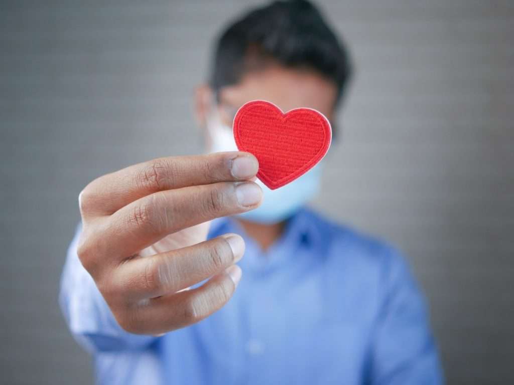 Person Holding Red Heart Ornament