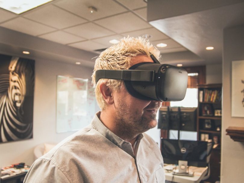 man standing and using virtual reality headset