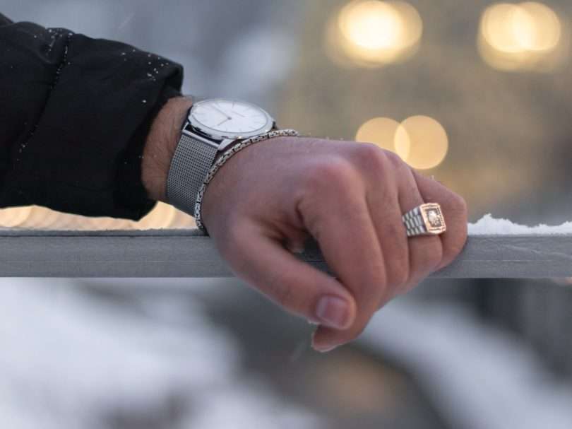 person wearing silver and white analog watch