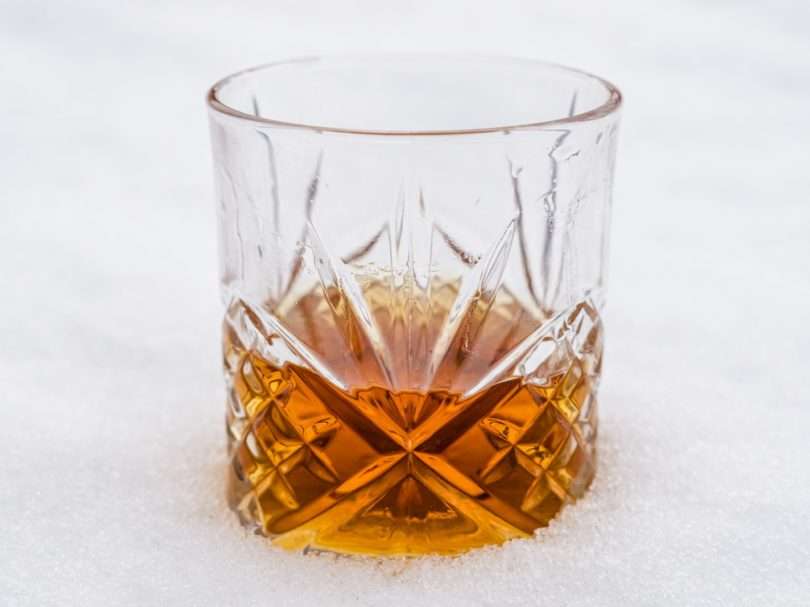 clear drinking glass with brown liquid