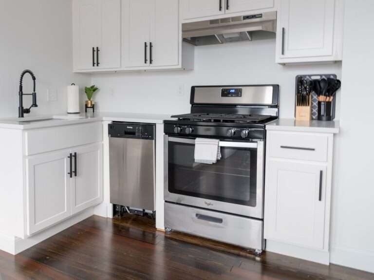 white wooden kitchen cabinet and white microwave oven
