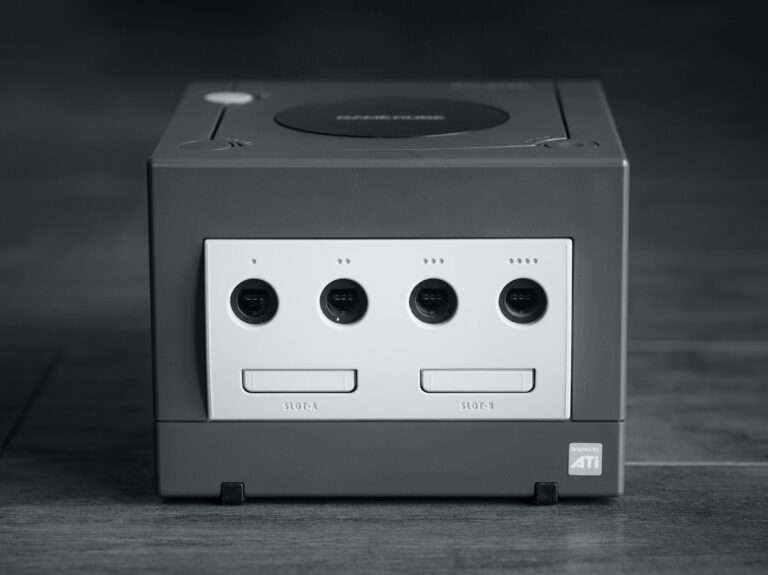 white and black Nintendo GameCube on gray surface