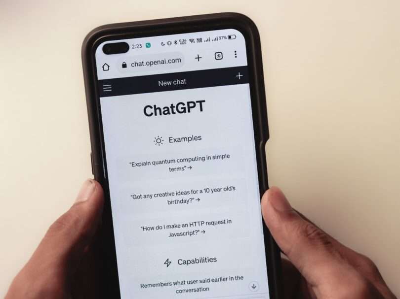 a person holding a cell phone with a chat app on the screen