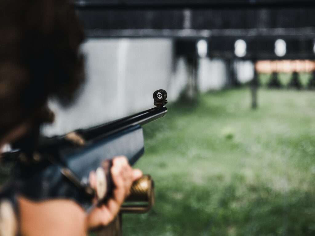 person aiming on the gun