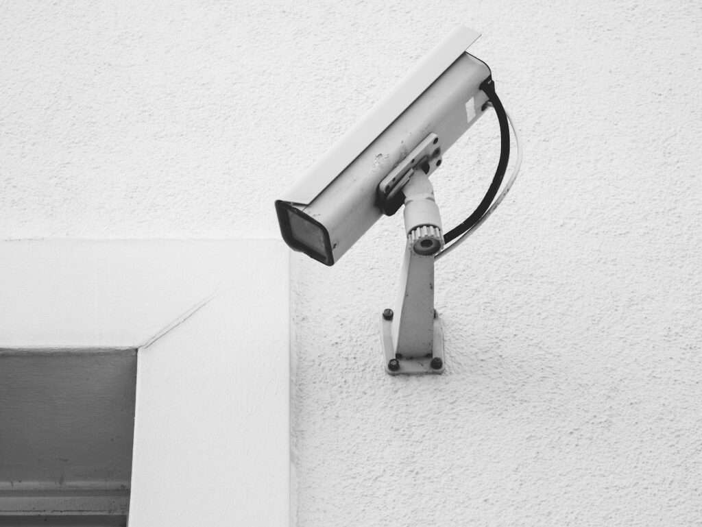 white security camera on white wall