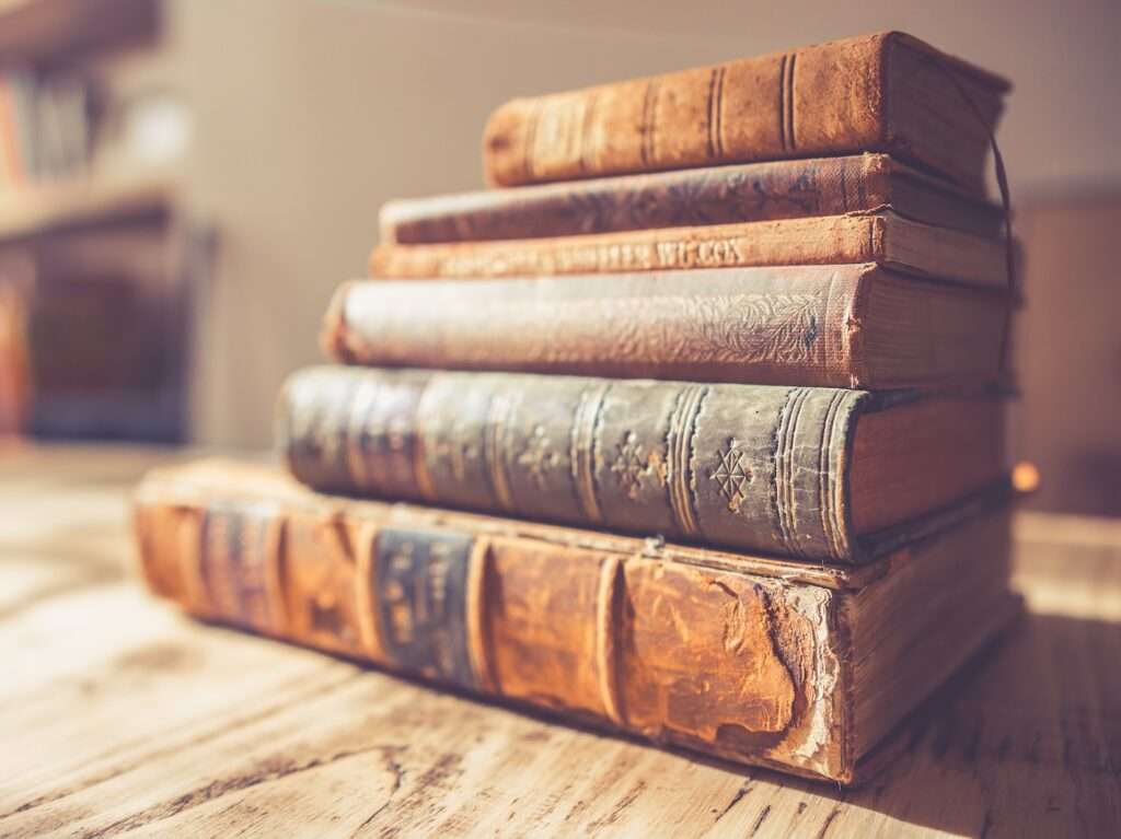 stack of six brown hardbound books