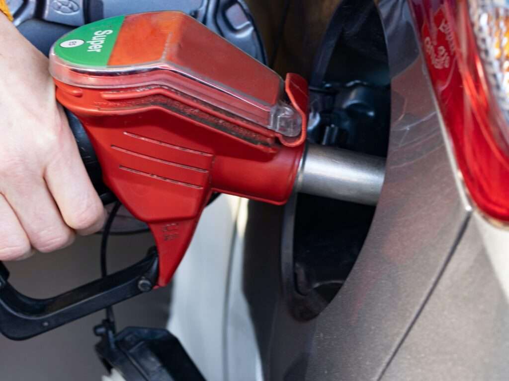 a person pumping gas into a car at a gas station