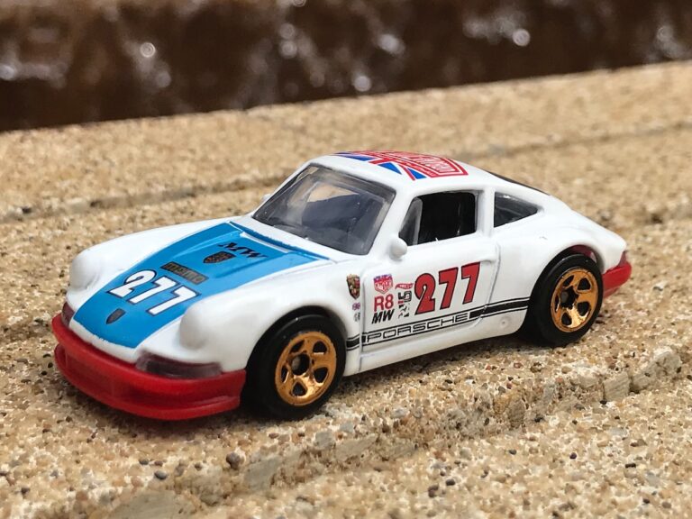 selective focus photography of white and blue 277 race coupe toy
